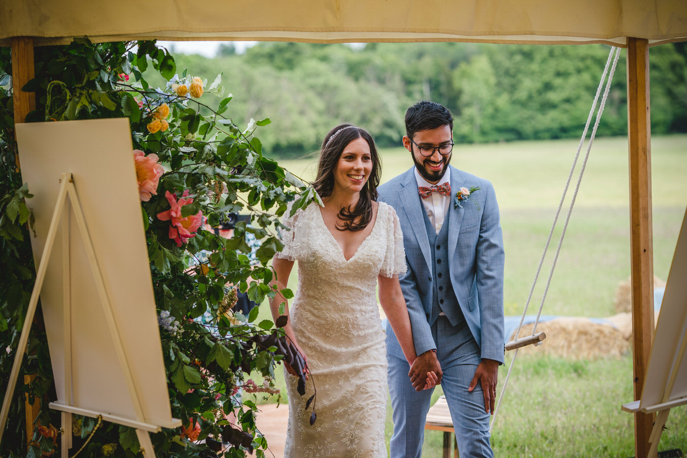 couple coming into a marquee
