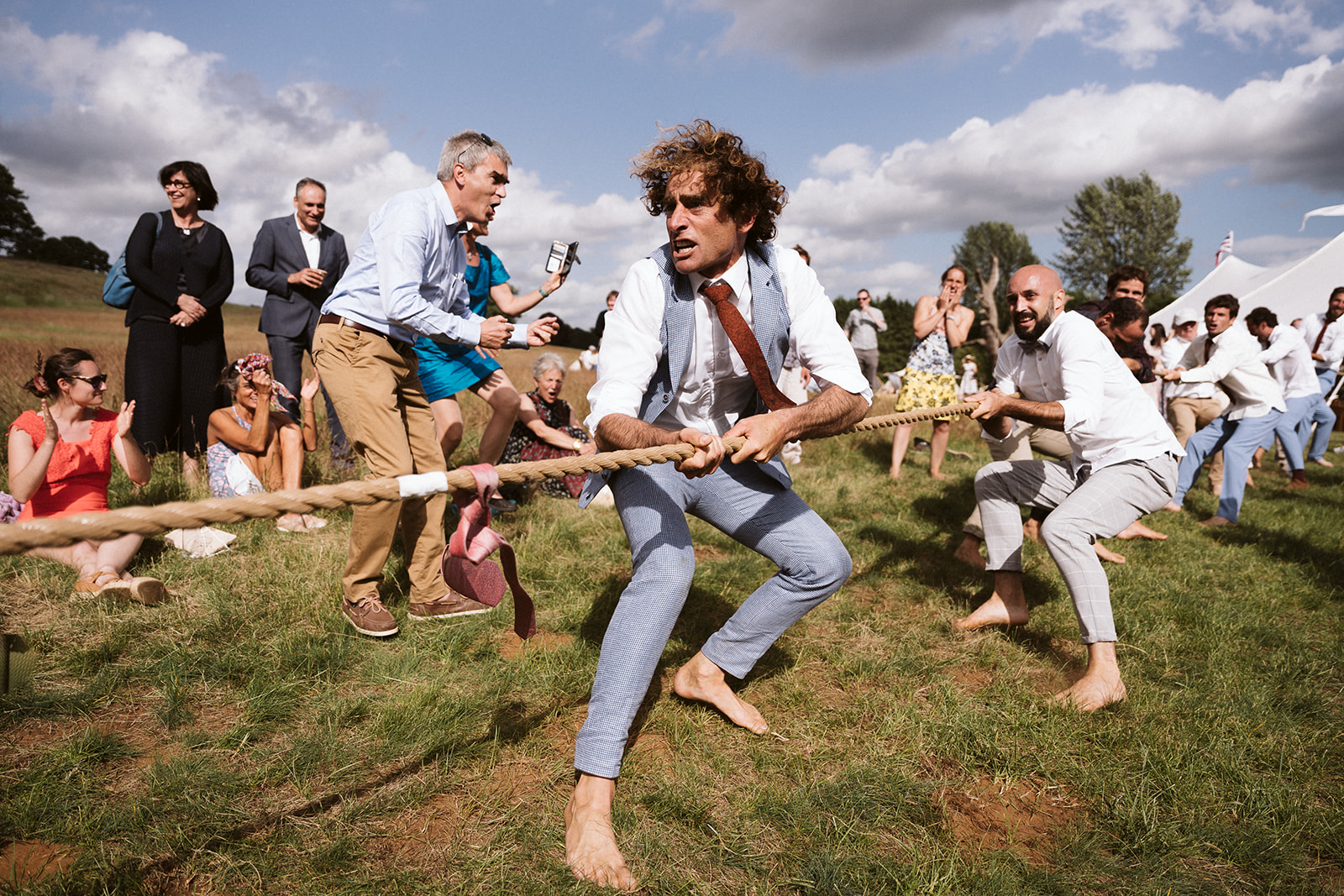 Groom and guests having a tug of war