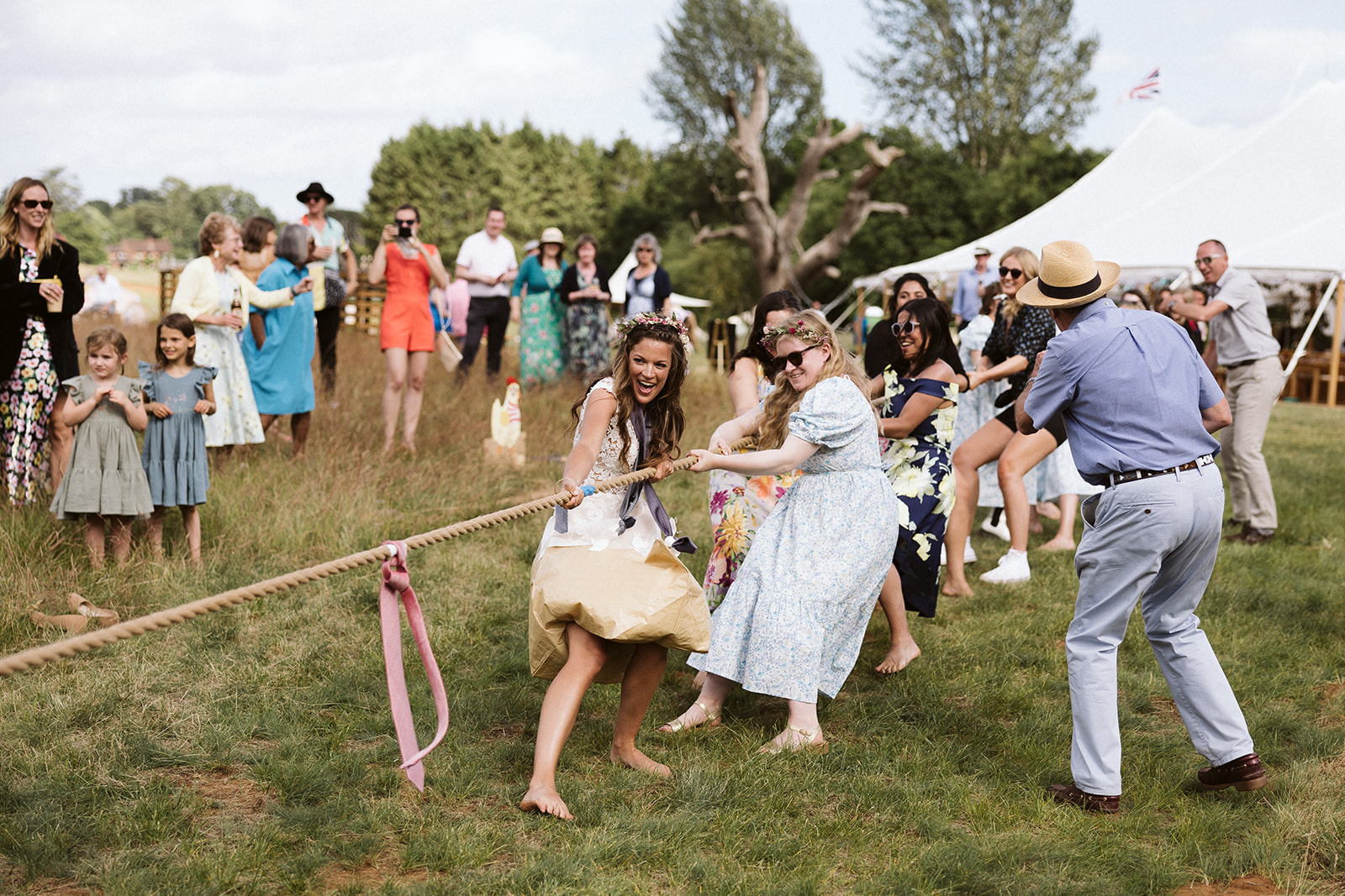 bride and guests in a tug of war
