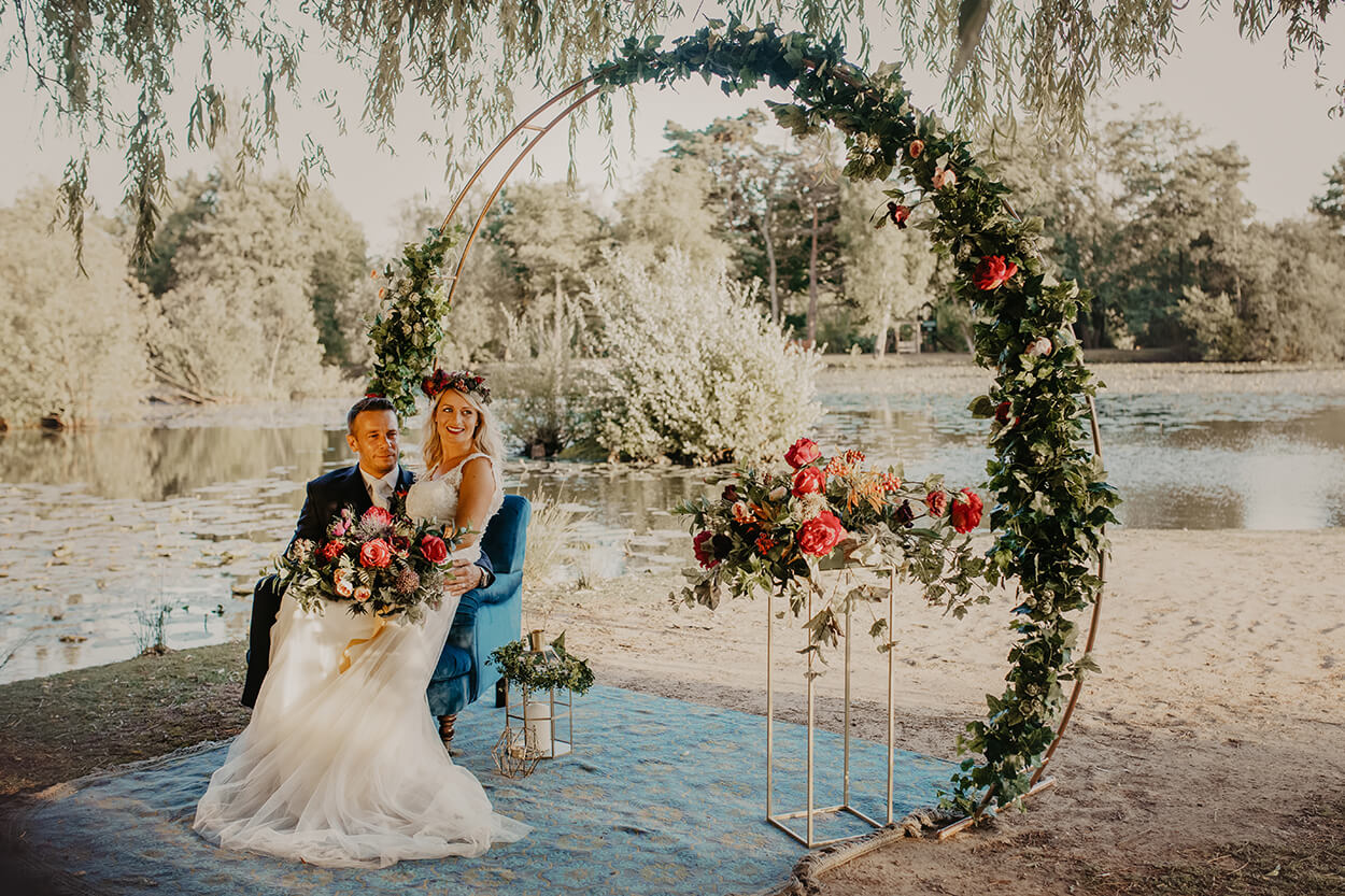 Couple in wedding  surrounded by faux blooms