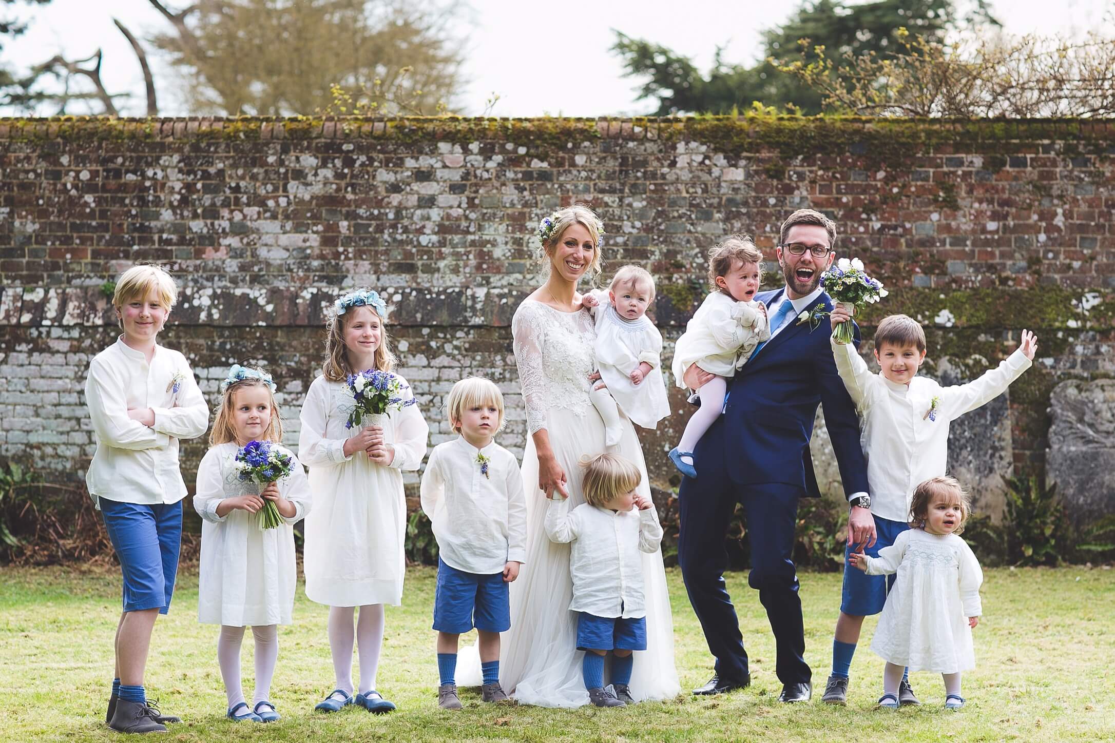 Family at a wedding beside a walled garden